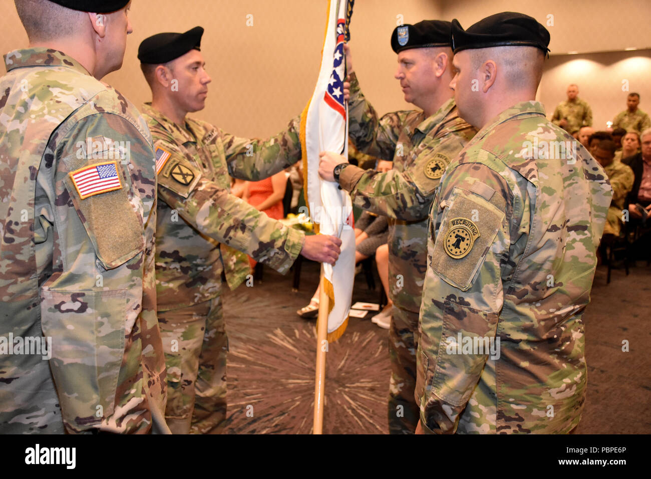Lt. Col. Matthew Mapes, 6th Medical Recruiting Battalion outgoing commander, relinquishes the battalion colors to Col. Edward Mandril, Medical Recruiting Brigade commander and presiding officer during the 6th MRBn Change of Command Ceremony on July 19. Stock Photo
