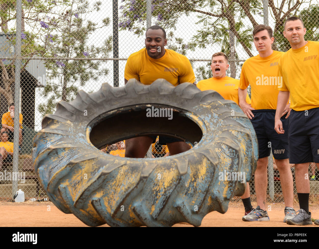 180720-N-PN275-1055 SAN DIEGO (July 20, 2018) Hospital Corpsman 2nd Class Trevor Tisby, center, flips a tire as part of Naval Medical Center San Diego’s Sailor Games, to observe the launch of Sailor 360. Sailor 360 is the Navy’s new leadership training curriculum, which is designed to provide meaningful training to Sailors of all ranks. (U.S. Navy Photo by Mass Communication Specialist 2nd Class Zach Kreitzer) Stock Photo