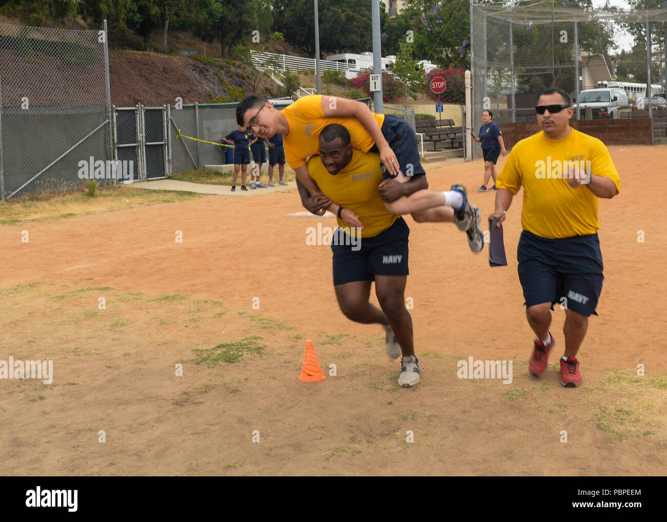 180720-N-PN275-1126 SAN DIEGO (July 20, 2018) Hospital Corpsman 2nd Class Trevor Tisby, carries Hospital Corpsman Seaman Apprentice Ryan Laburada for an obstacle course in Naval Medical Center San Diego’s Sailor Games to observe the launch of Sailor 360. Sailor 360 is the Navy’s new leadership training curriculum, which is designed to provide meaningful training to Sailors of all ranks. (U.S. Navy Photo by Mass Communication Specialist 2nd Class Zach Kreitzer) Stock Photo
