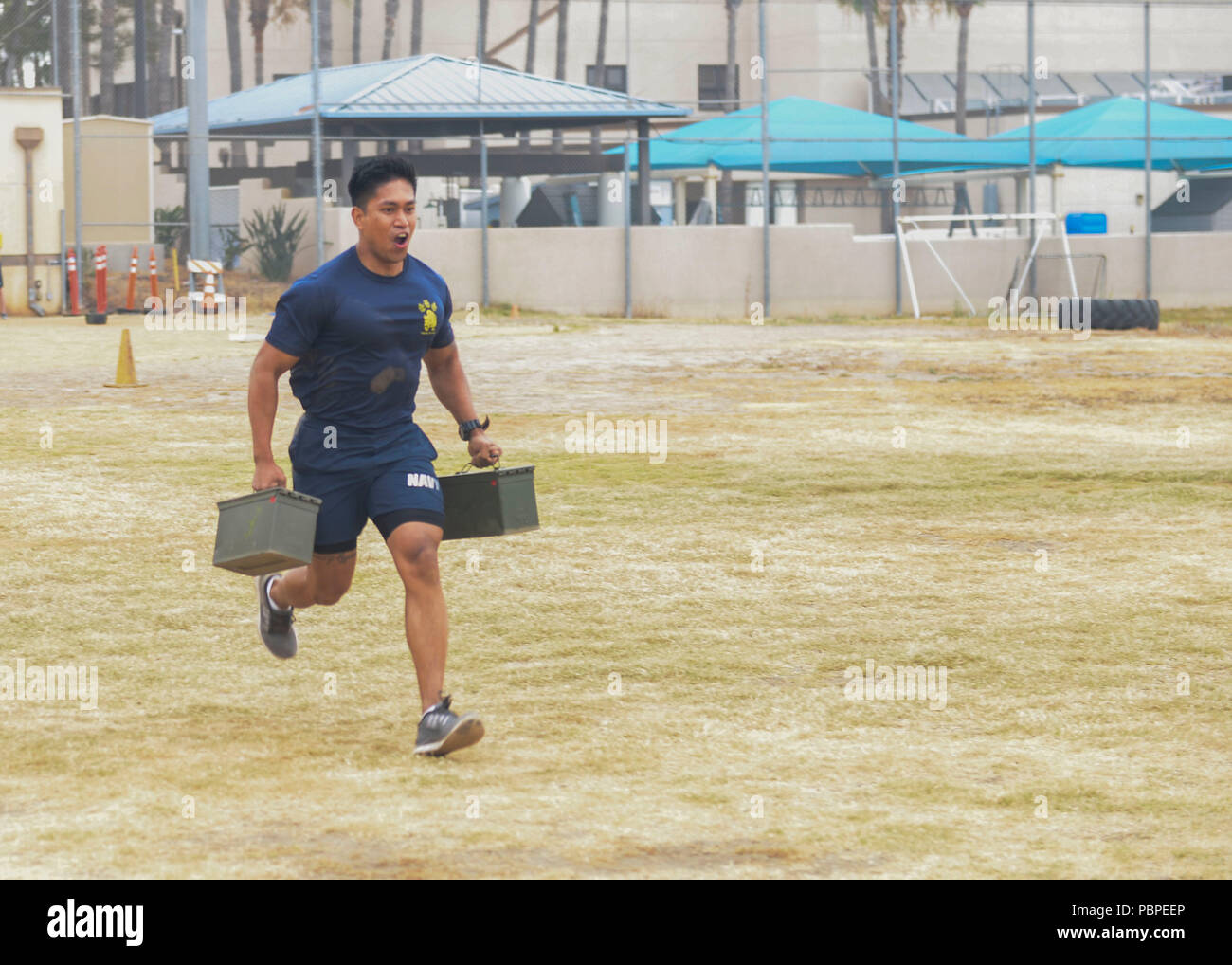 180720-N-PN275-1173 SAN DIEGO (July 20, 2018) Chief Hospital Corpsman Paul Barnachea  runs with ammo cans for an obstacle course in Naval Medical Center San Diego’s Sailor Games to observe the launch of Sailor 360. Sailor 360 is the Navy’s new leadership training curriculum, which is designed to provide meaningful training to Sailors of all ranks. (U.S. Navy Photo by Mass Communication Specialist 2nd Class Zach Kreitzer) Stock Photo