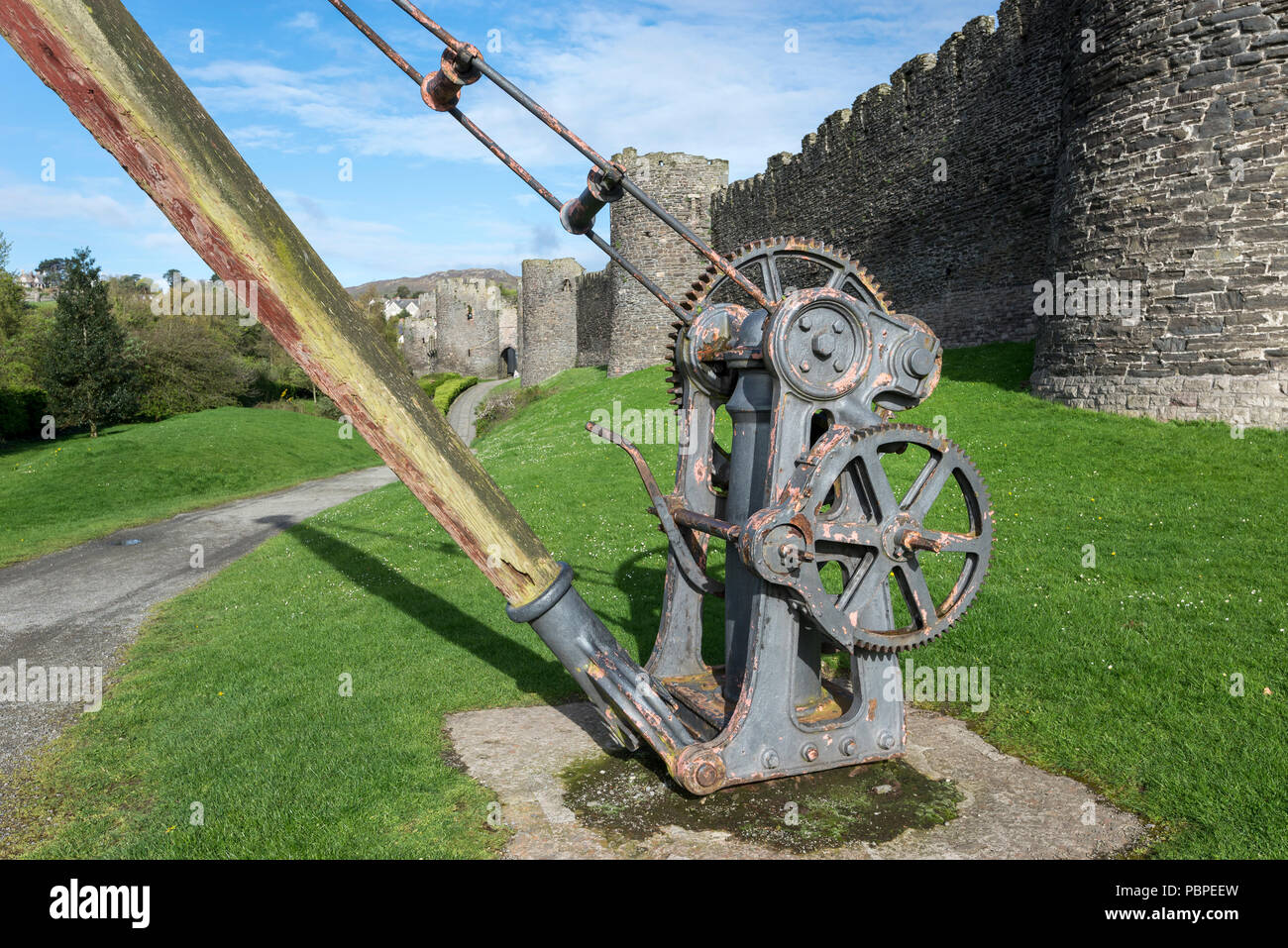 Old lifting gear beside the medieval stone walls at Conwy, North Wales, UK. Stock Photo