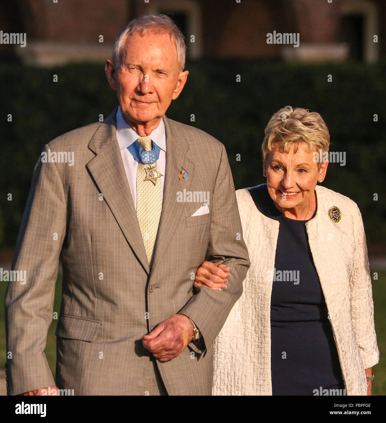 Major Gen. James E. Livingston, Medal of Honor recipient, and his wife, Sara Livingston, walk down Center Walk, during a Friday Evening Parade at Marine Barracks Washington D.C., July 20, 2018. Livingston was the guest of honor for the parade and the hosting official was Lt. Gen. Brian D. Beaudreault, deputy commandant, Plans, Policies and Operations. (Official Marine Corps photo by Cpl. Damon Mclean/Released) Stock Photo