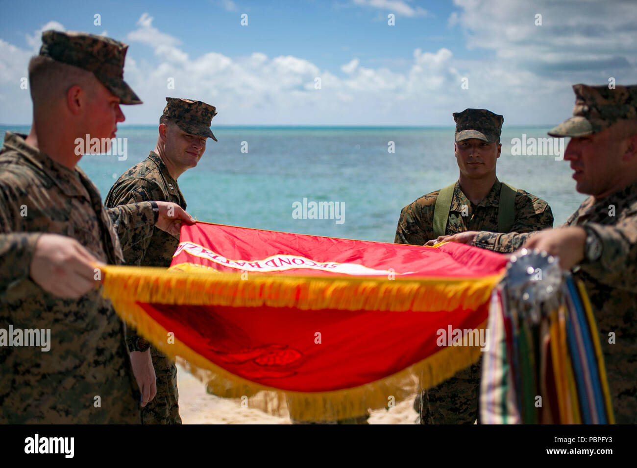 U.S. Marines assigned to 2nd Battalion, 8th Marine Regiment, stow away their battle colors after a battle sites tour in Tarawa, Kiribati, July 22, 2018. The tour was held on the 75th anniversary of the battalion’s assault on Red Beach 3 to foster the battalion’s history program and incentivize outstanding performance for select Marines and Sailors. 2/8 is forward deployed to 3rd Marine Division in Okinawa, Japan as part of the unit Deployment Program. (U.S. Marine Corps photo by Cpl. Charles Plouffe) Stock Photo