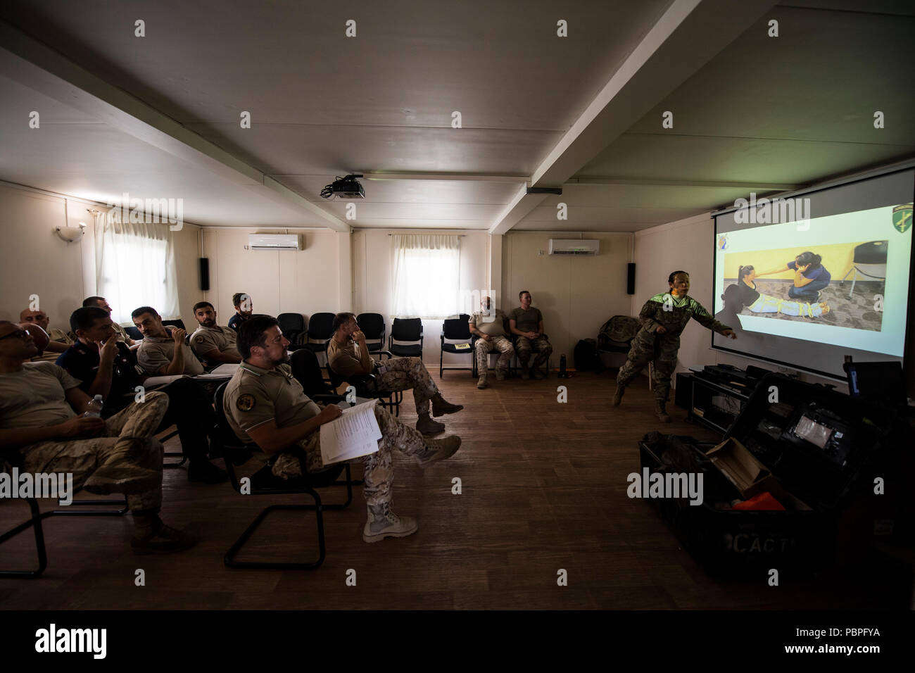U.S. Army Capt Stacey Suttles, a physician assistant assigned to the 404th Civil Affairs Battalion, Airborne, leads a block of instruction during the combat lifesaver skills course at the Base Militare Italiana di Supporto, Djibouti, July 20, 2018. The joint-coalition force CLS training provided an opportunity to teach new combat life saving procedures, while strengthening operational capabilities between both nations.  (U.S. Air Force photo by Tech. Sgt. Larry E. Reid Jr.) Stock Photo