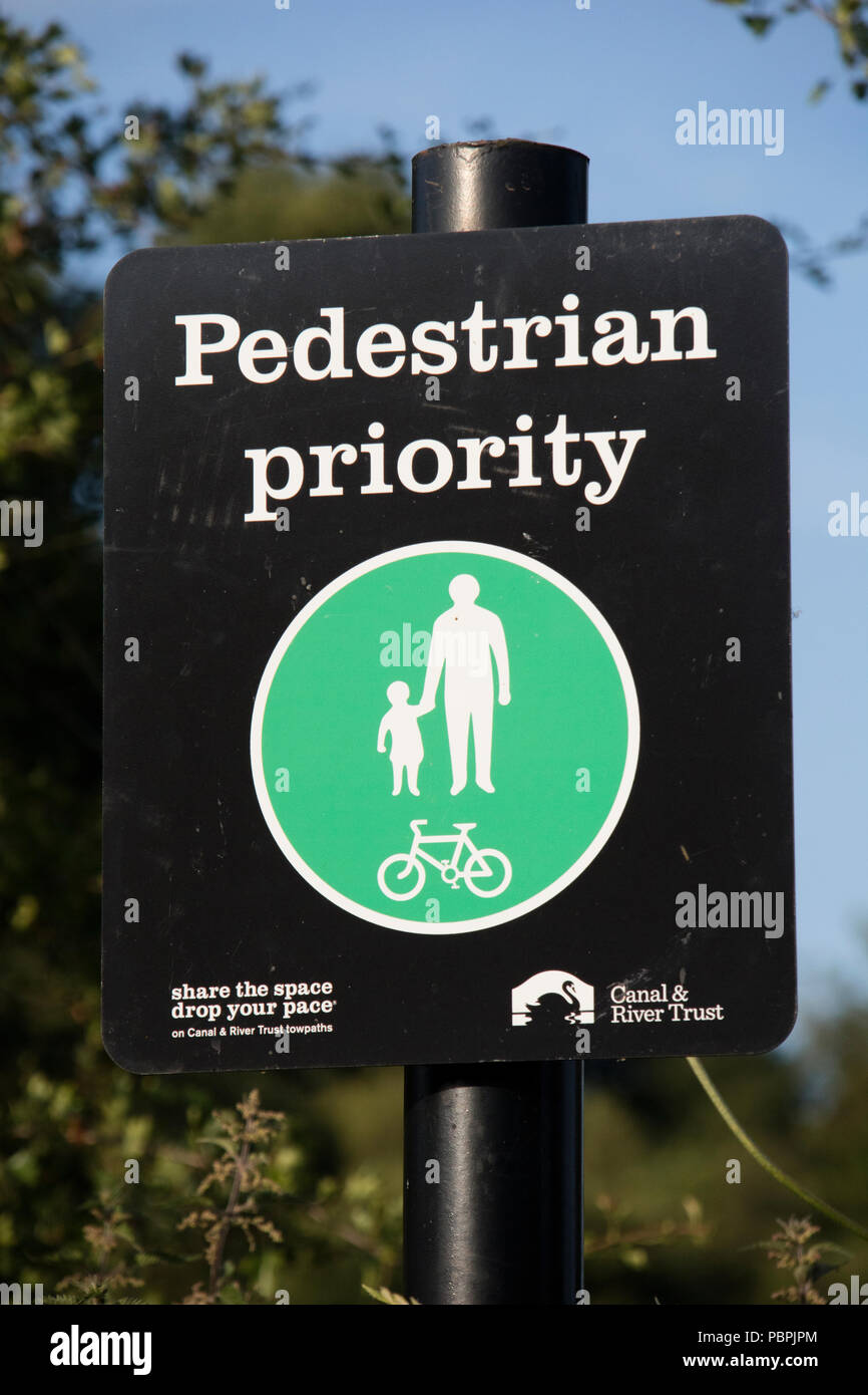 Pedestrian priority sign on a canal towpath, England, UK Stock Photo