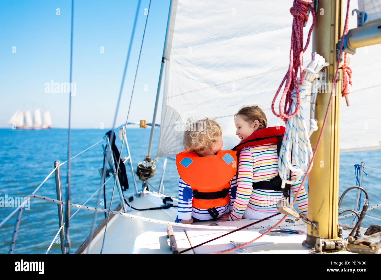 Kids sail on yacht in sea. Child sailing on boat. Little boy and girl