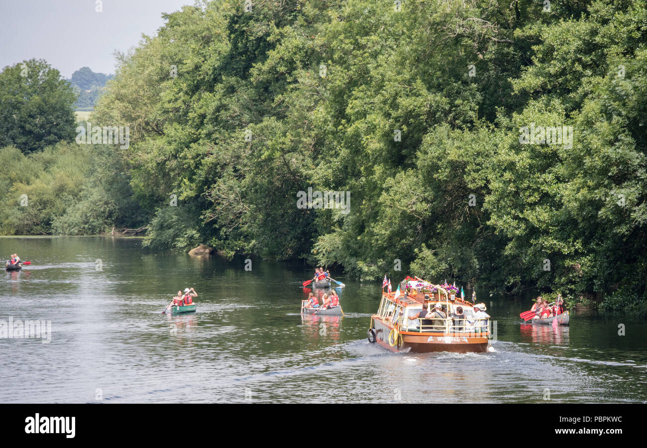 A trip boat on the River Wye at Symonds Yat East passing people in canoes,  Herefordshire, England, UK Stock Photo