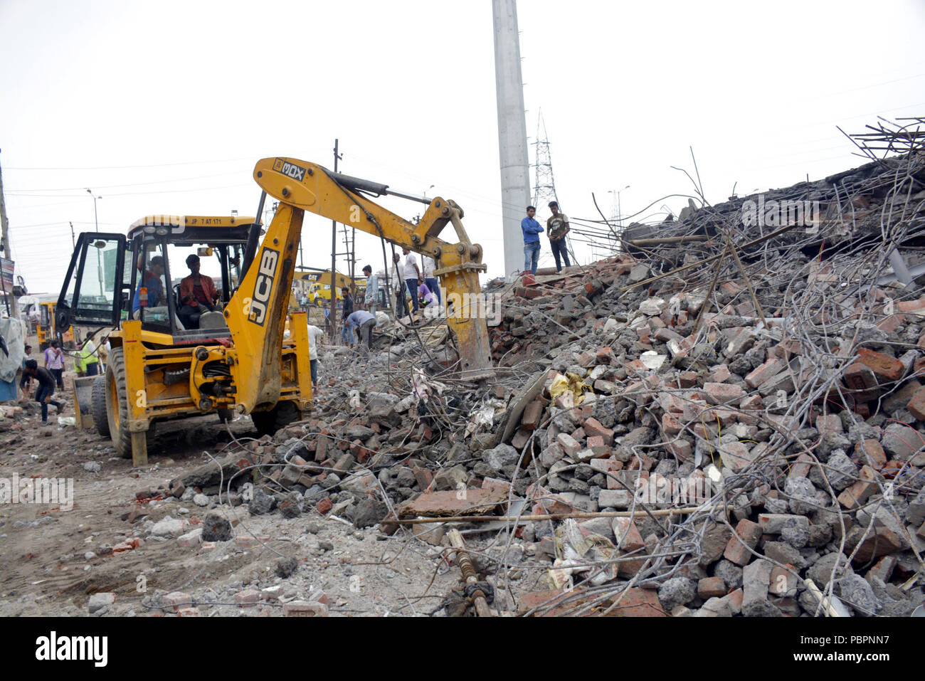 Ghaziabad, India. 28th July, 2018. Members of National Disaster Response Force (NDRF) team work at the site after a five-storeyed building collapsed in Ghaziabad, India, July 28, 2018. Credit: Stringer/Xinhua/Alamy Live News Stock Photo