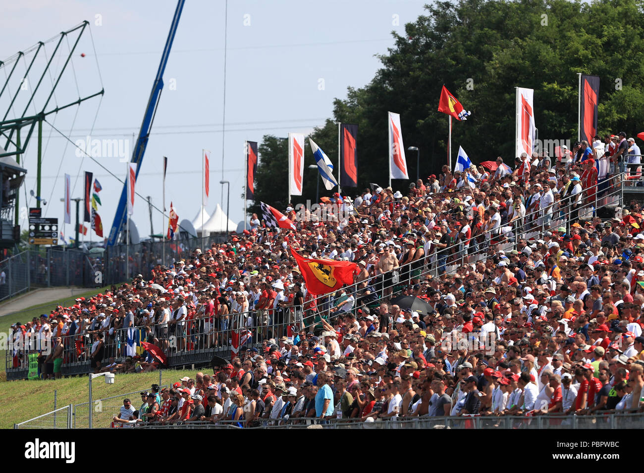 Hungaroring, Mogyorod, Hungary. 29th July, 2018. Hungarian Formula One Grand Prix, race day; A Ferrari flag is waved during the minute of silence for Sergio Marchionne Credit: Action Plus Sports/Alamy Live News Stock Photo