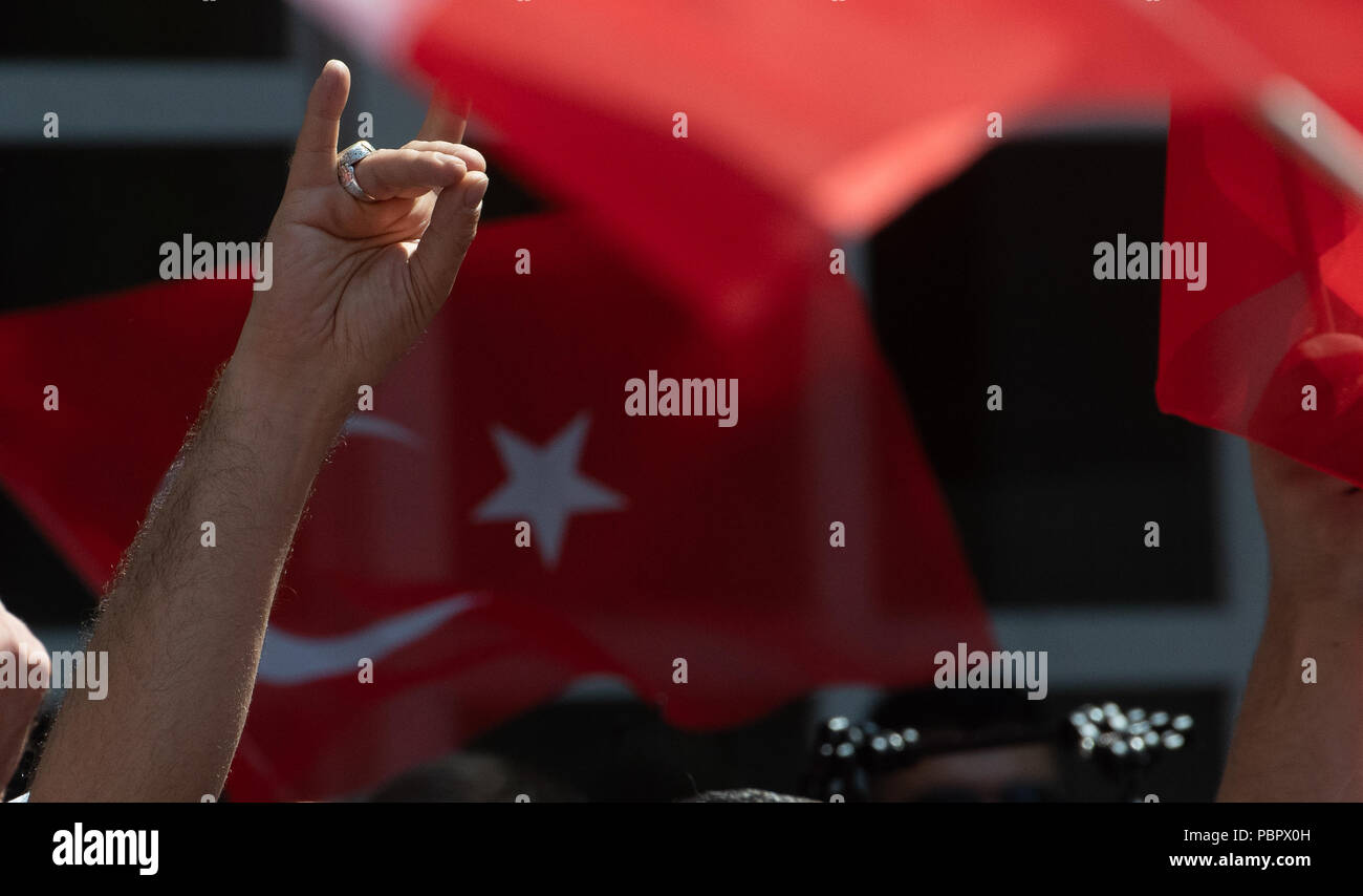 Berlin, Germany. 29th July, 2018. Demonstrators carrying Turkish flags standing in front of the Axel Springer building. Several people took part in protests against what they considered unfair media coverage of footballer M. Ozil and Turkish President Erdogan. The protests had the motto 'I am Ozil'. Credit: Paul Zinken/dpa/Alamy Live News Stock Photo