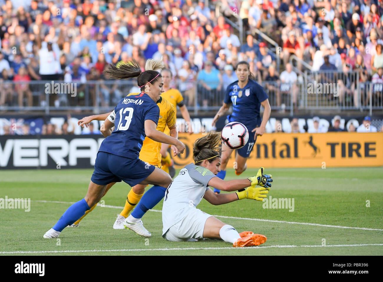 East Hartford Conn, USA. 29th July, 2018. Australia goalkeeper Lydia Williams (1) tries to capture the loose ball as USA forward Alex Morgan (13) circles from behind during the Tournament of Nations match between the women's national teams of the United States and Australia, held at the Pratt and Whitney Stadium, in East Hartford Conn. Eric Canha/CSM/Alamy Live News Stock Photo
