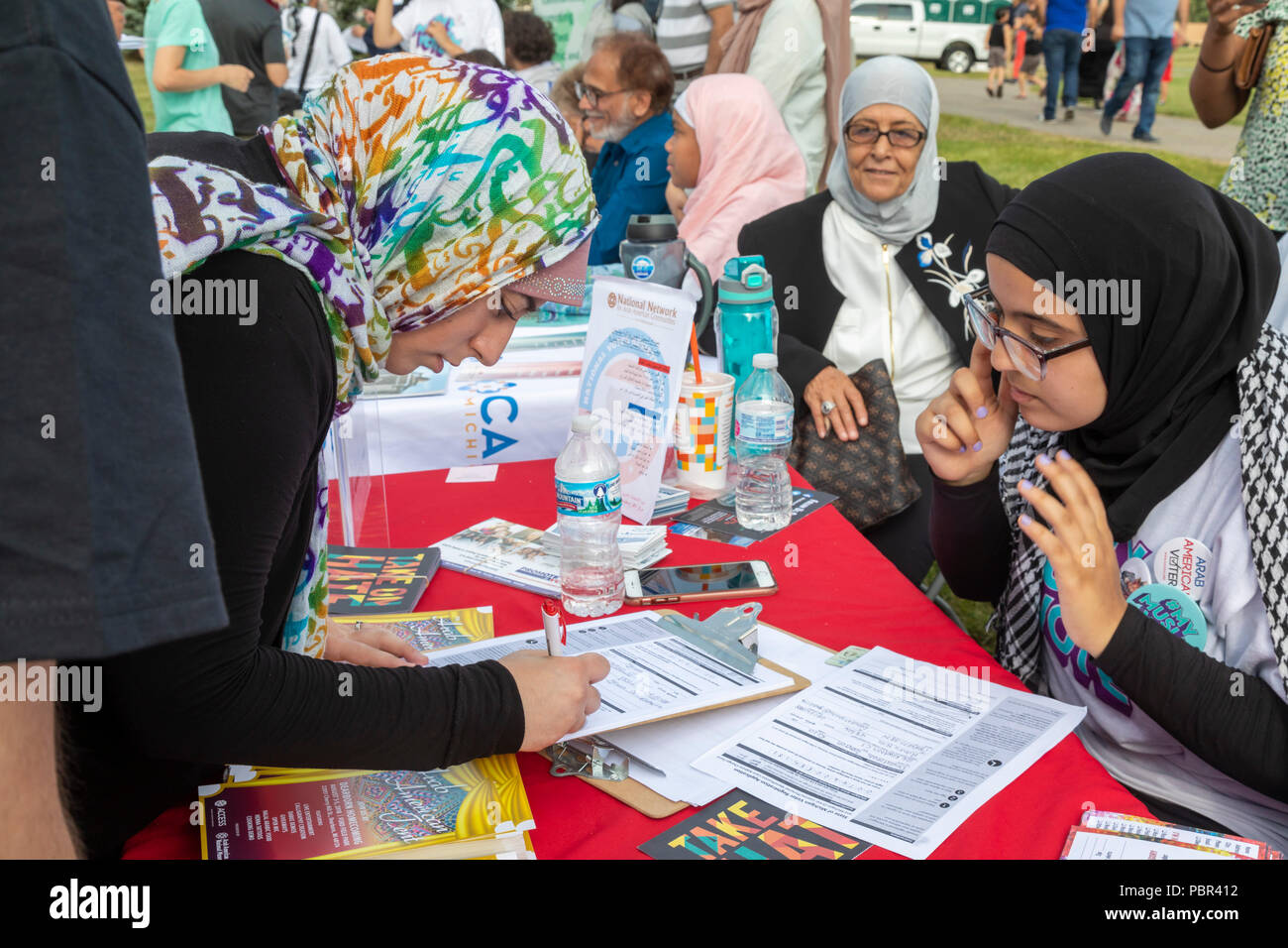 Dearborn, Michigan USA - 29 July 2018 - A woman registers to vote at a Muslim Get Out the Vote rally, sponsored by several Muslim community organizations. The rally featured entertainment and speeches from Muslim and other progressive political candidates. Credit: Jim West/Alamy Live News Stock Photo