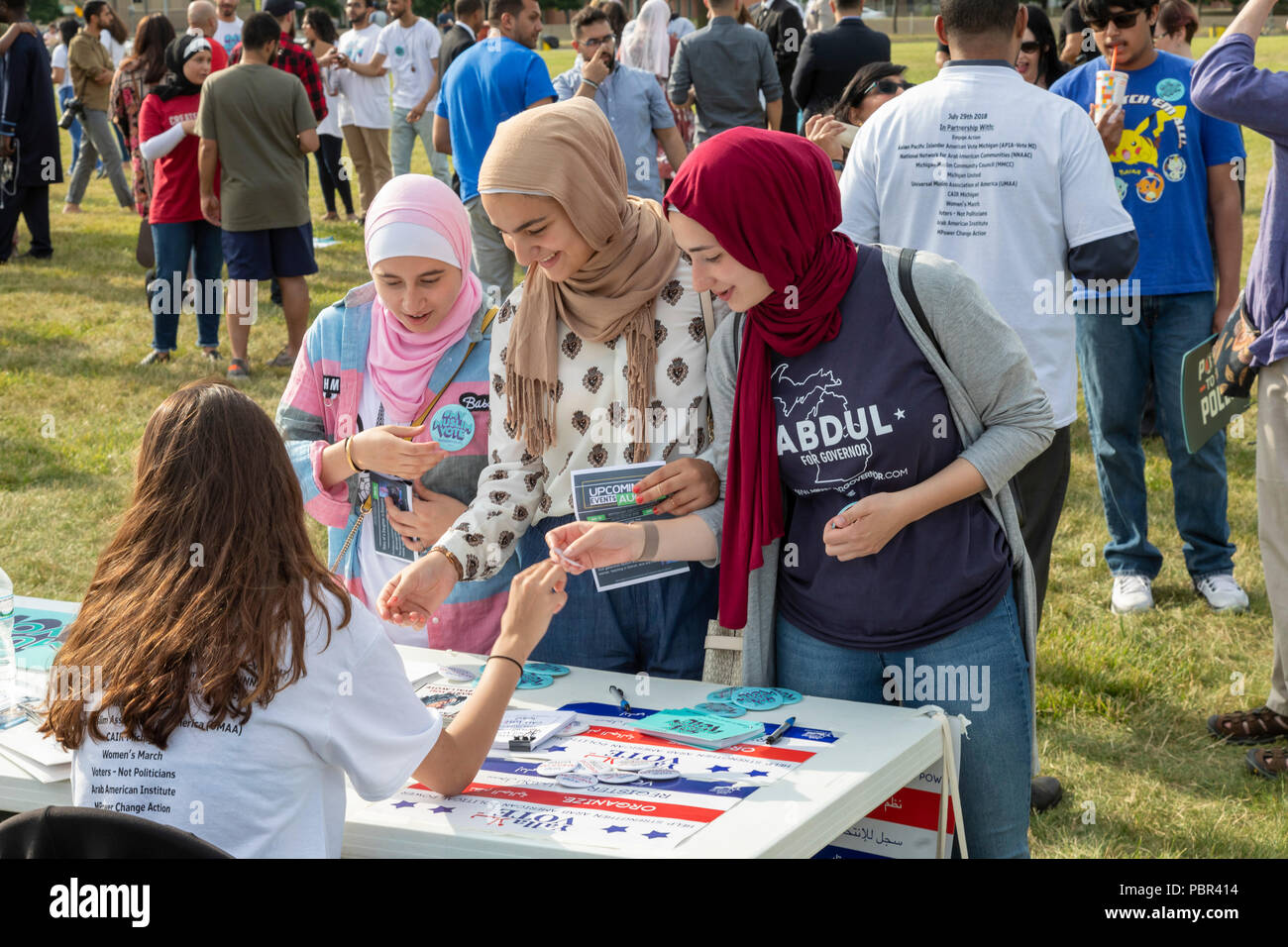 Dearborn, Michigan USA - 29 July 2018 - Women pick up literature at a Muslim Get Out the Vote rally, sponsored by several Muslim community organizations. The rally featured entertainment and speeches from Muslim and other progressive political candidates. Credit: Jim West/Alamy Live News Stock Photo