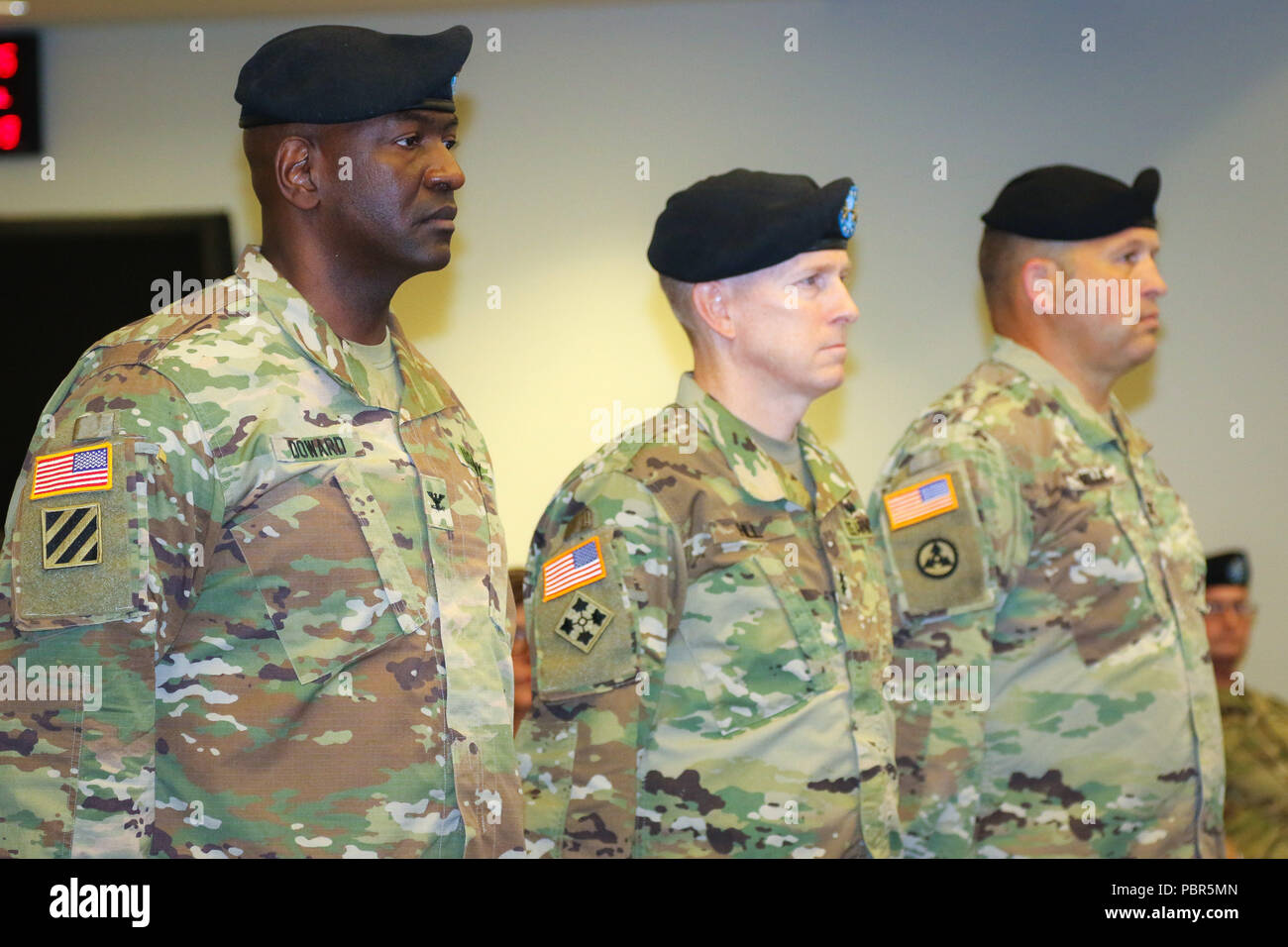 Col. Oscar W. Doward Jr., outgoing commander of the 2503rd Digital Liaison Detachment, Maj. Gen. David C. Hill, deputy commanding general, U.S. Army Central, and Col. Douglas W. Mills, incoming commander of the 2503rd DLD, stand at attention during a change-of-command ceremony July 19, 2018, at Patton Hall on Shaw Air Force Base, S.C. (U.S. Army photo by Sgt. Von Marie Donato) Stock Photo