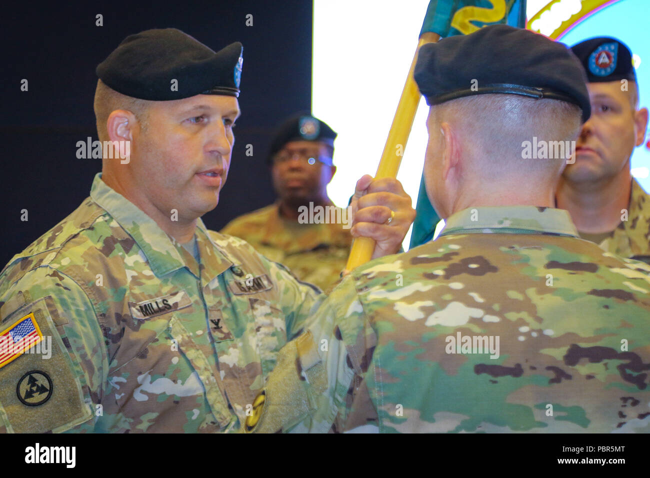 Col. Douglas W. Mills, incoming commander of the 2503rd Digital Liaison Detachment, receives the unit colors from Maj. Gen. David C. Hill, deputy commanding general, U.S. Army Central, during a change-of-command ceremony July 19, 2018, at Patton Hall on Shaw Air Force Base, S.C. (U.S. Army photo by Sgt. Von Marie Donato) Stock Photo