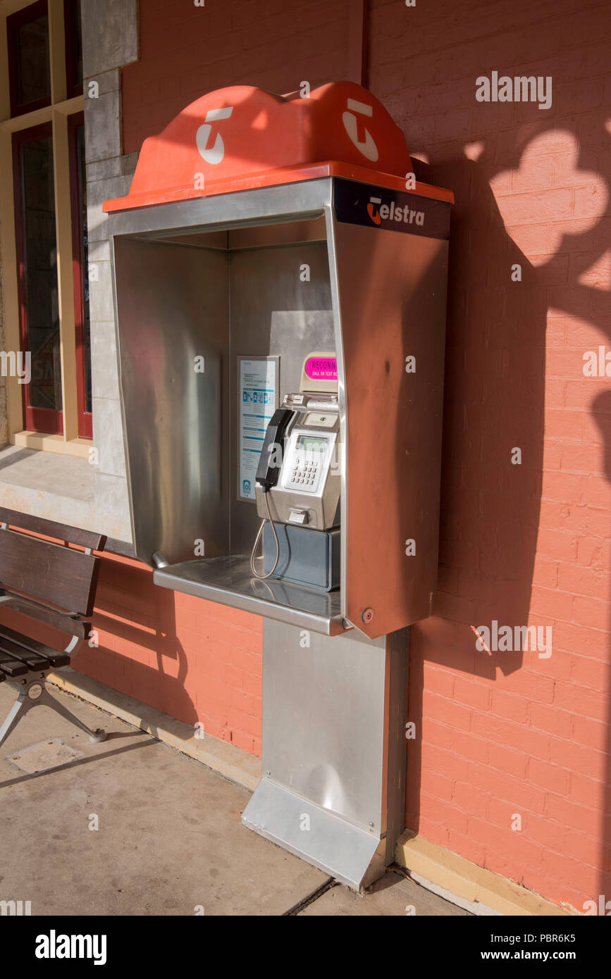 Bathurst NSW; A Telstra pay phone sits mounted on the wall of the railway station. Phone such as these are now largely redundant due to mobile phones Stock Photo
