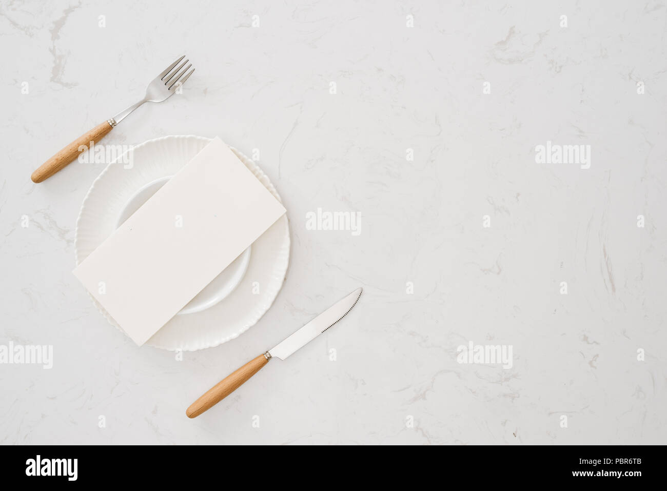white plate without food with a fork and knife Stock Photo
