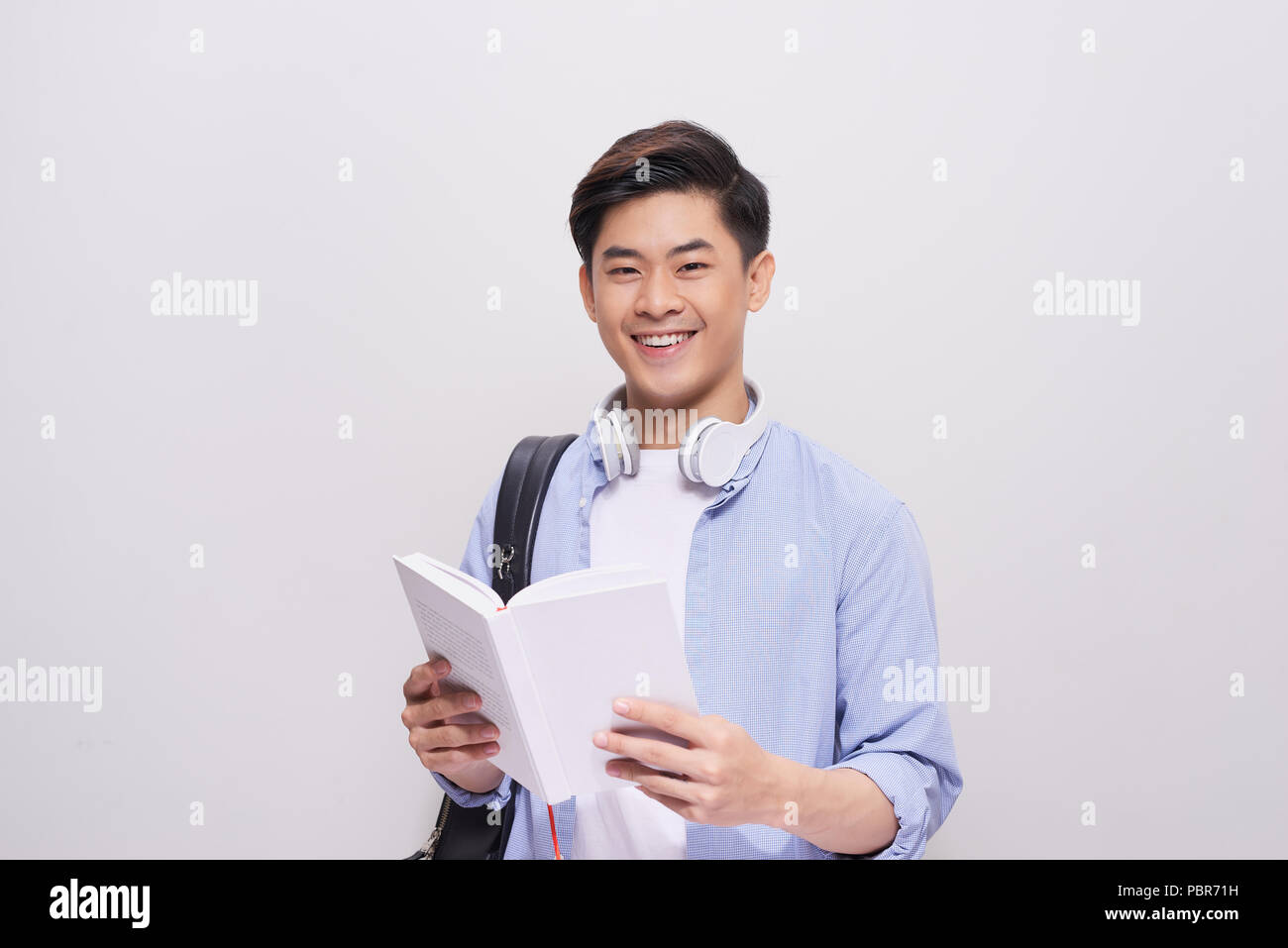 Confident asian handsome student holding books Stock Photo