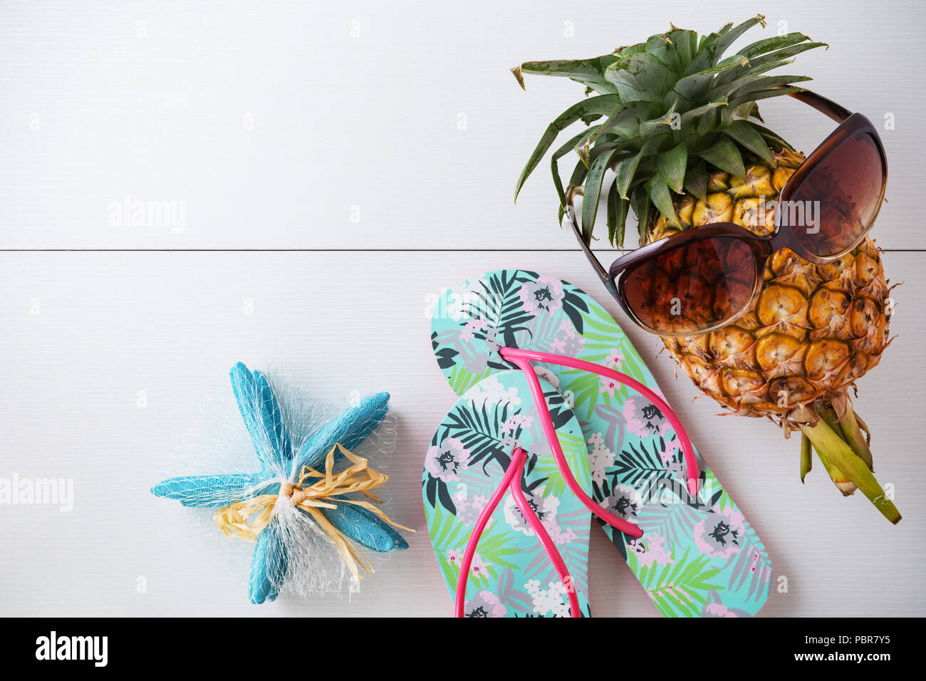 Summer beach vacation background with sunglasses on pineapple and flip ...