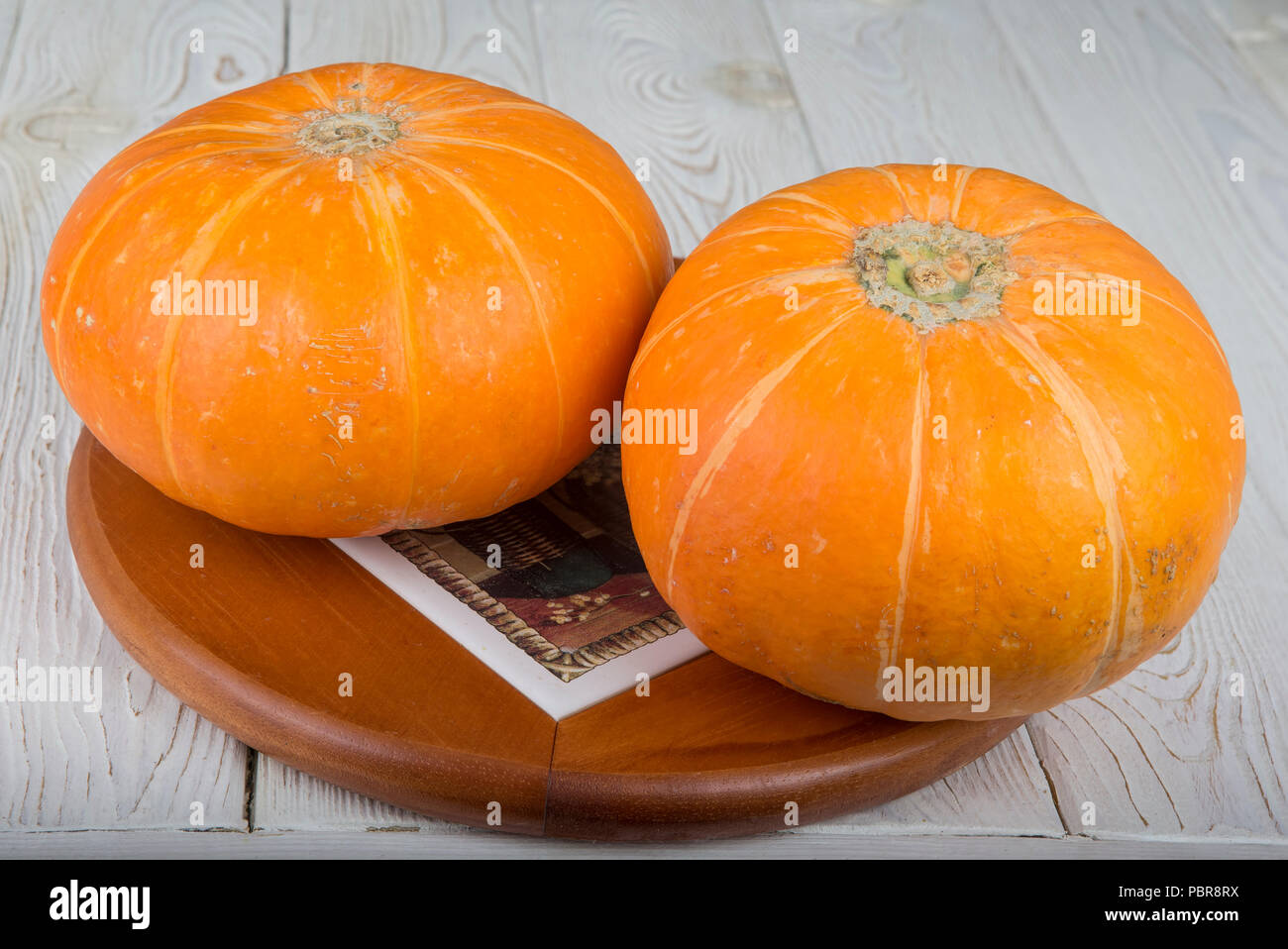 Ripe fresh pumpkin. On a wooden table Stock Photo