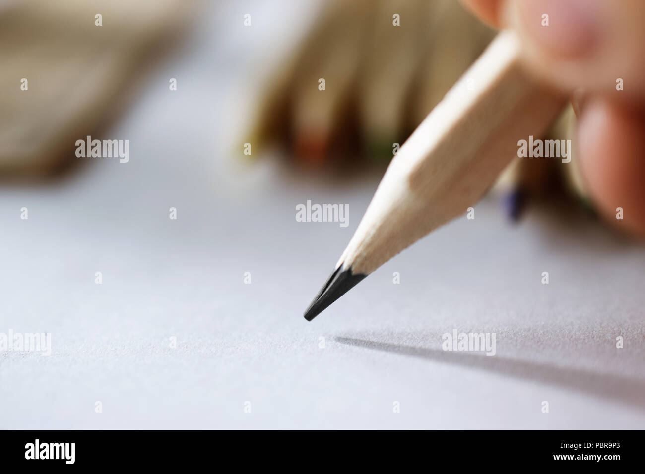 artist's hand sketching with a simple pencil, close-up Stock Photo