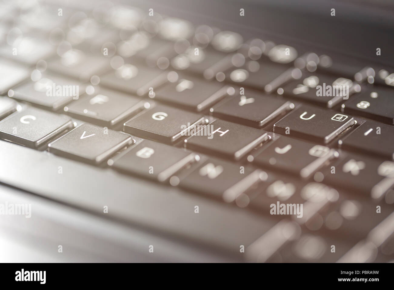 Macro view of black laptop keyboard buttons against back light Stock ...