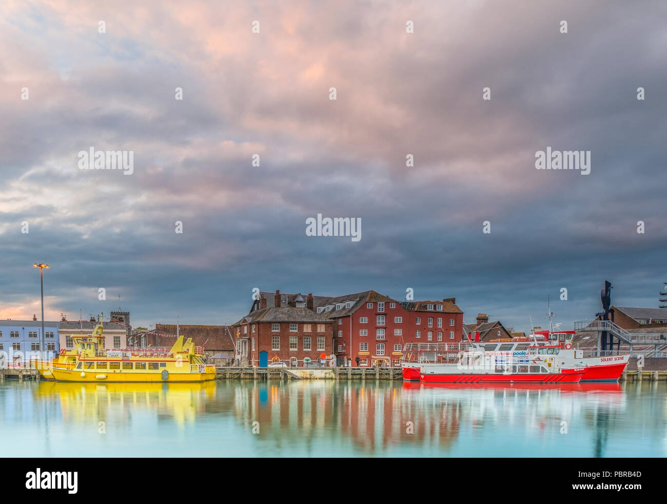 Poole quay in Dorset during a cloudy colourful sunset Stock Photo