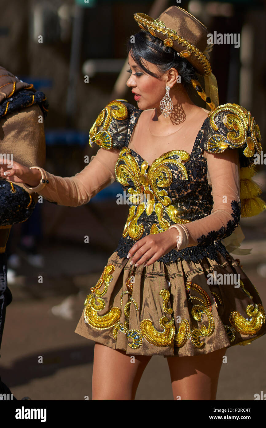 Caporales dancers in ornate costumes performing as they parade through