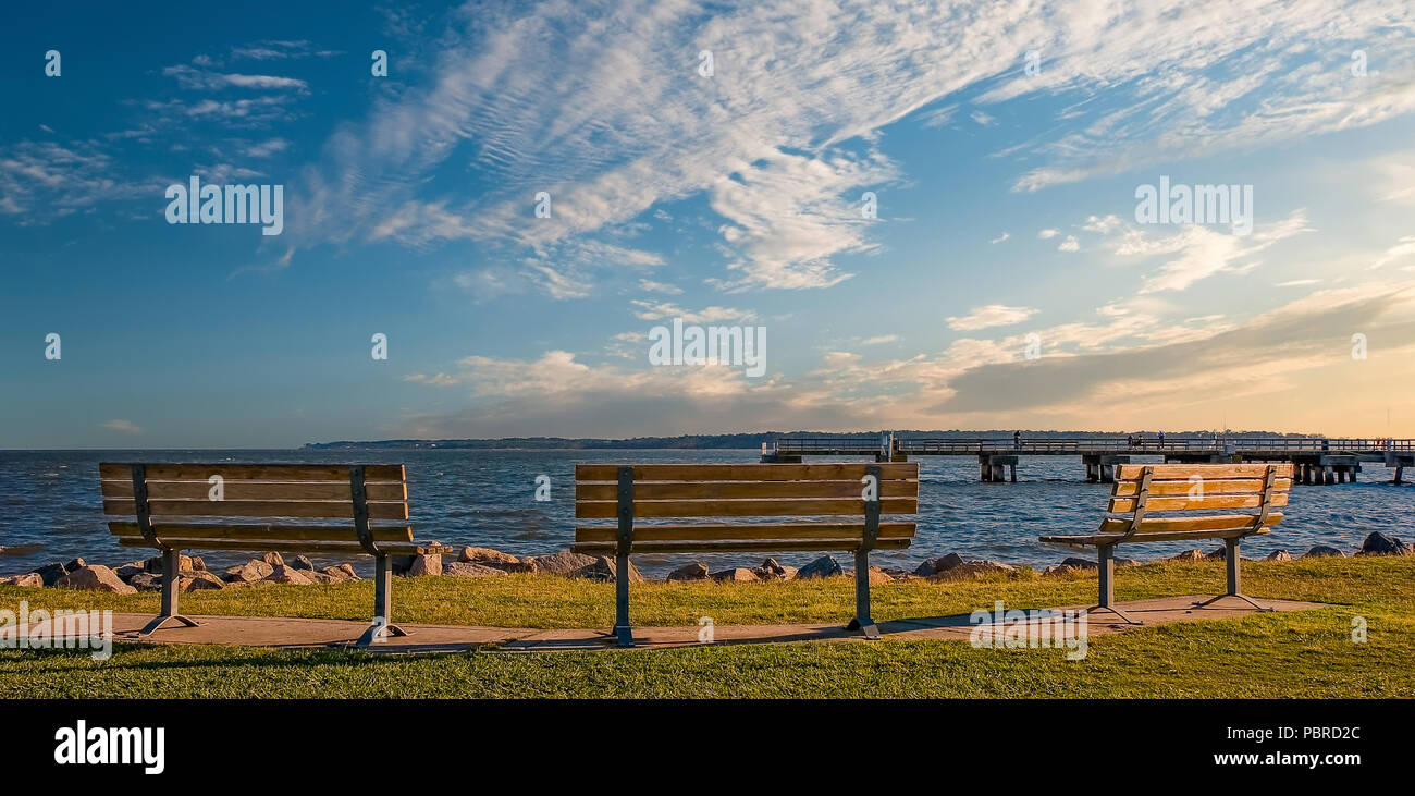 Three empty benches on the coast with blue sky Stock Photo - Alamy