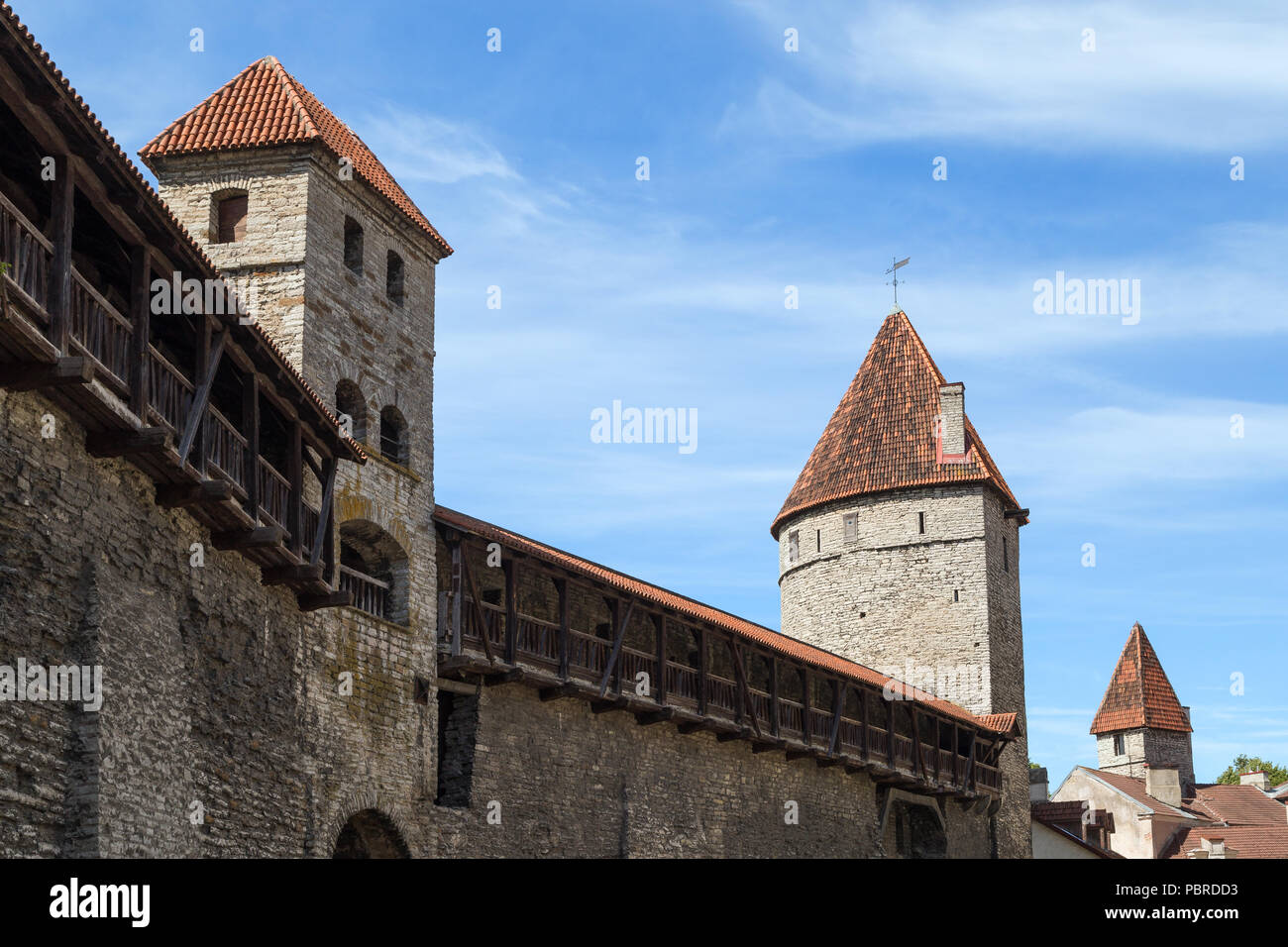 Medieval city wall (or Town Wall or Walls of Tallinn) and towers at the Old Town in Tallinn, Estonia, on a sunny day in the summer. Stock Photo