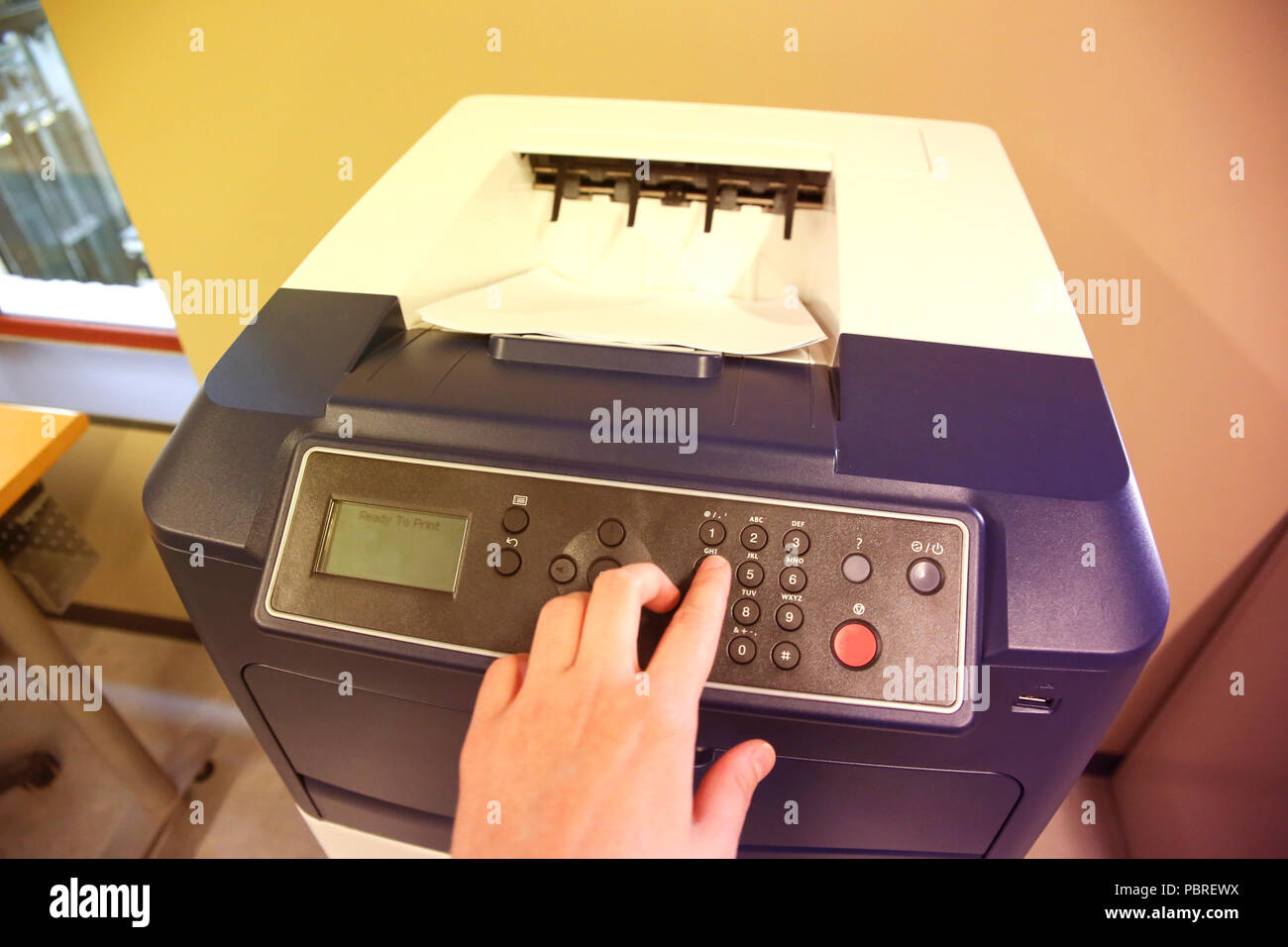 Close-up of a business assistant using a printer Stock Photo