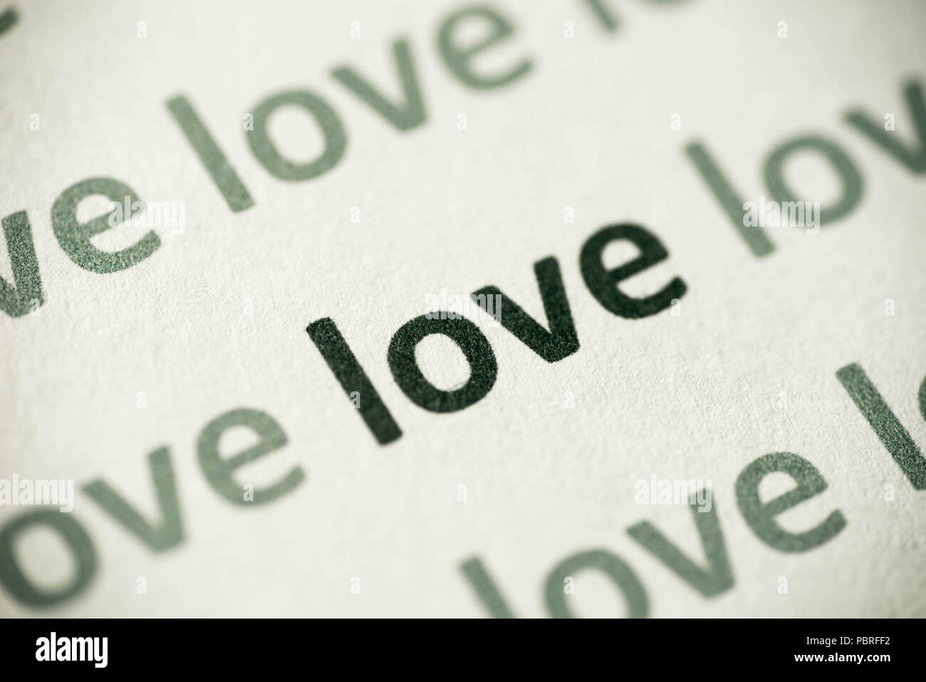 word love printed on white paper macro Stock Photo