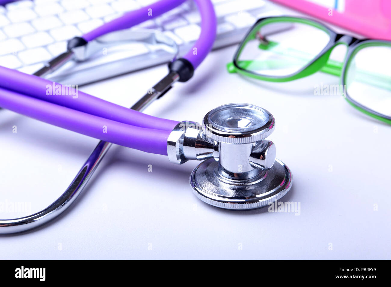 Medical record concept with stethoscope over pile of folders. Keyboard
