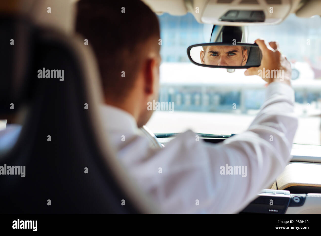 Serious smart man fixing the rearview mirror Stock Photo Alamy