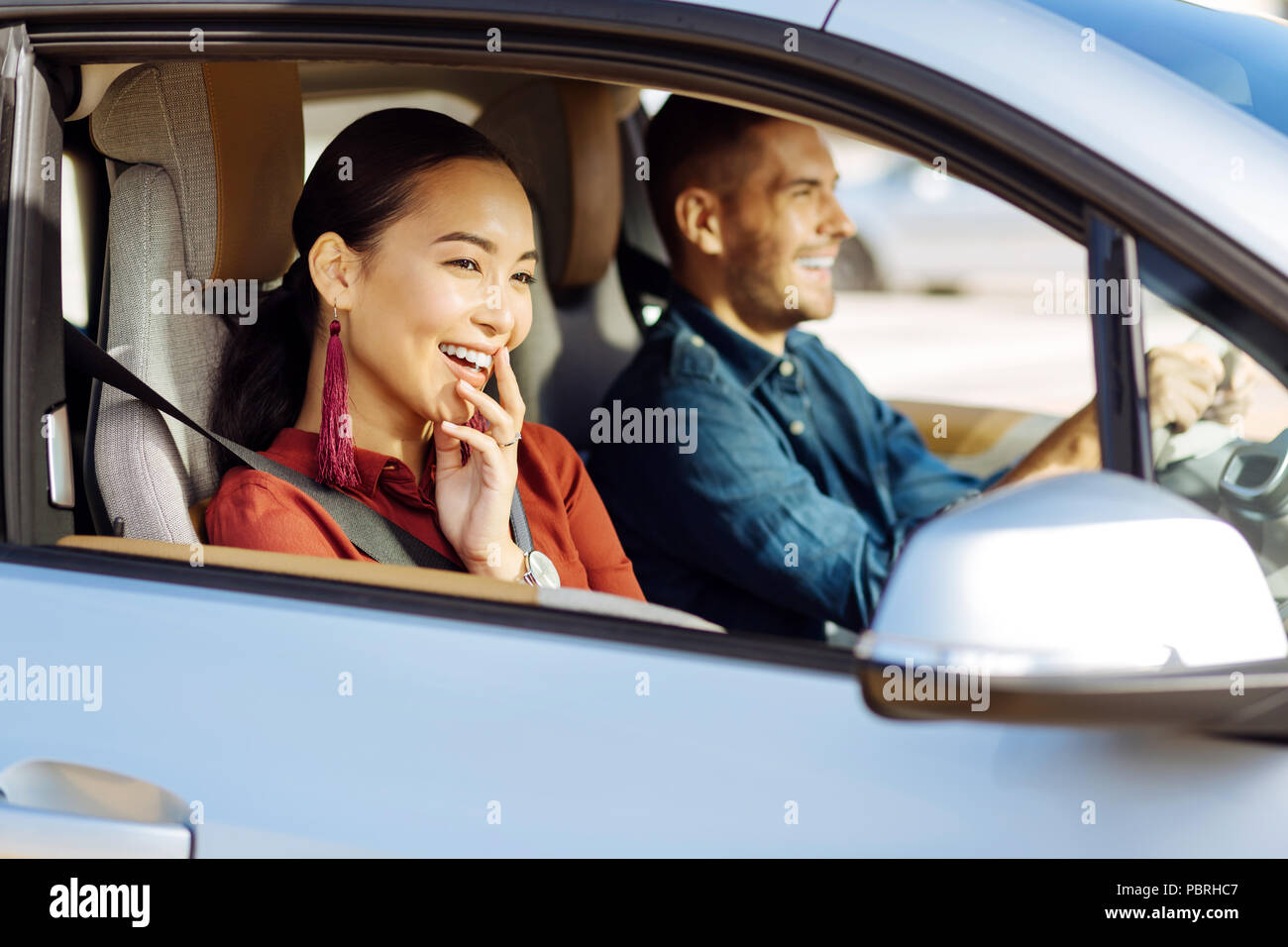 Happy nice woman looking out of the window Stock Photo - Alamy