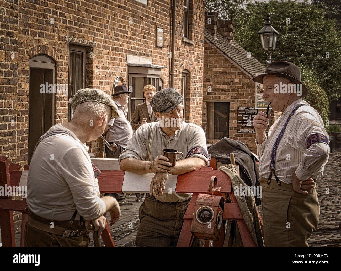 WW2 home life: re-enactors as home front wartime road workers in 1940's street, Black Country Living Museum Dudley, UK, summer 1940's WWII event. Stock Photo