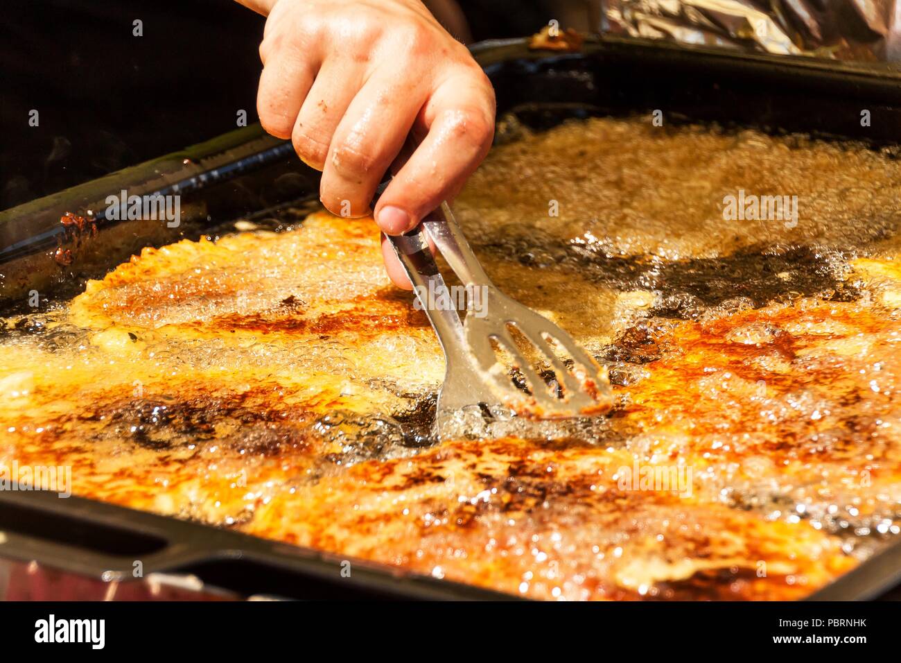 Frying potato pancakes in hot oil. Potato pancakes in a pan