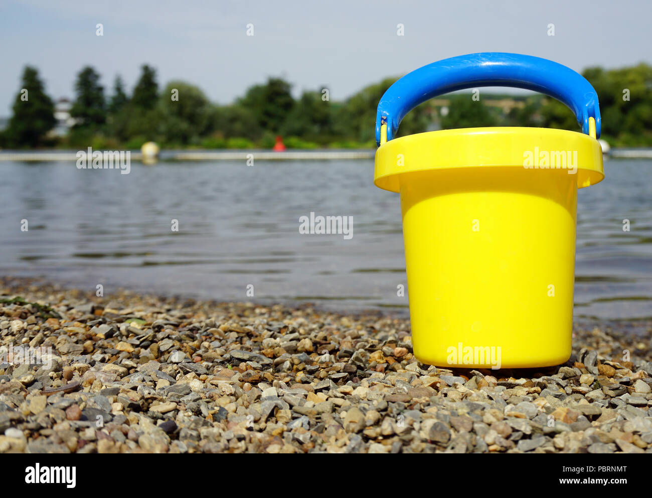 yellow bucket at beach Stock Photo Alamy