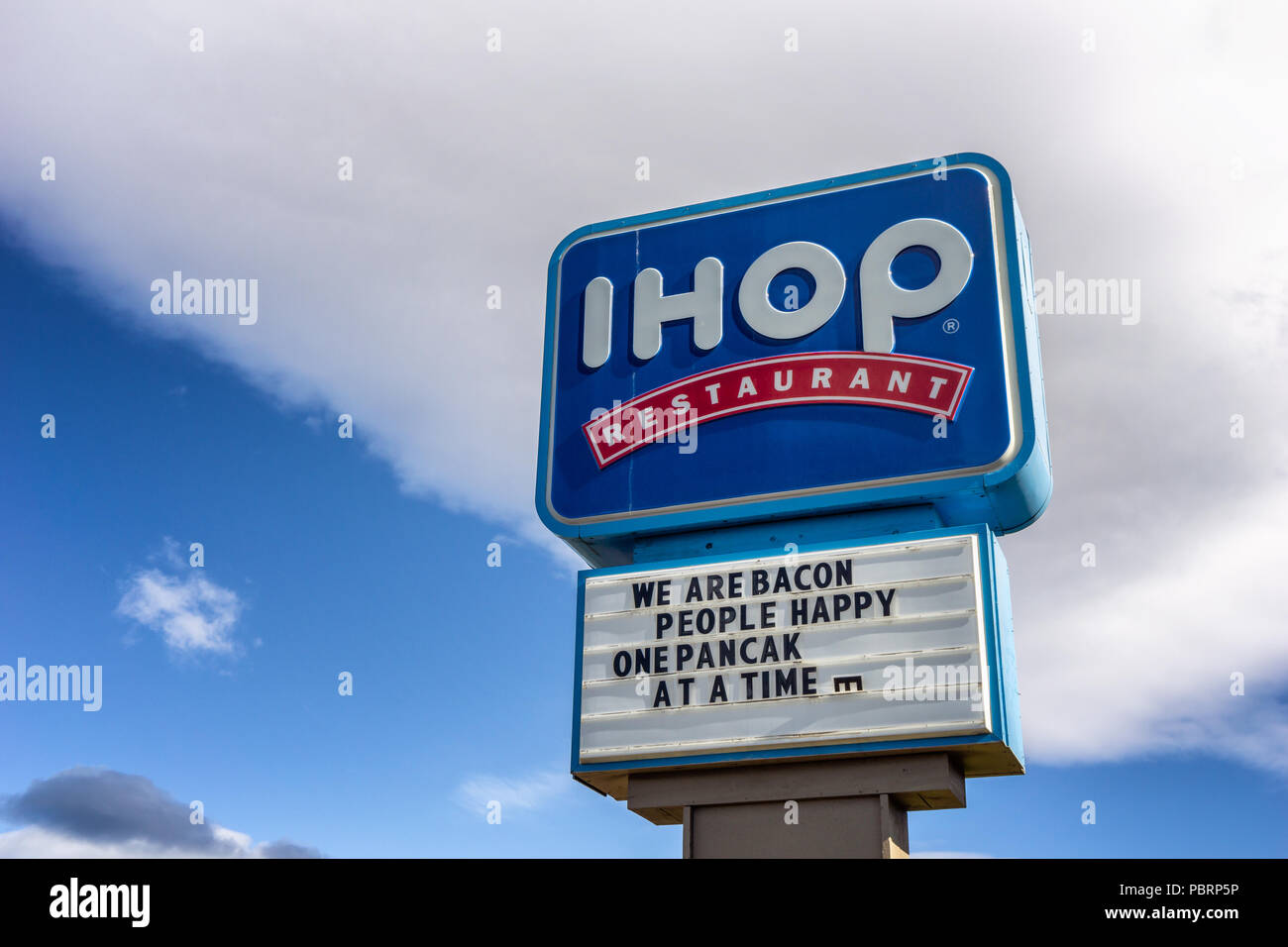 IHOP restaurant chain brand signboard with headlines We are bacon people happy, One pancake at a timei, Bend, Oregon, USA. Stock Photo