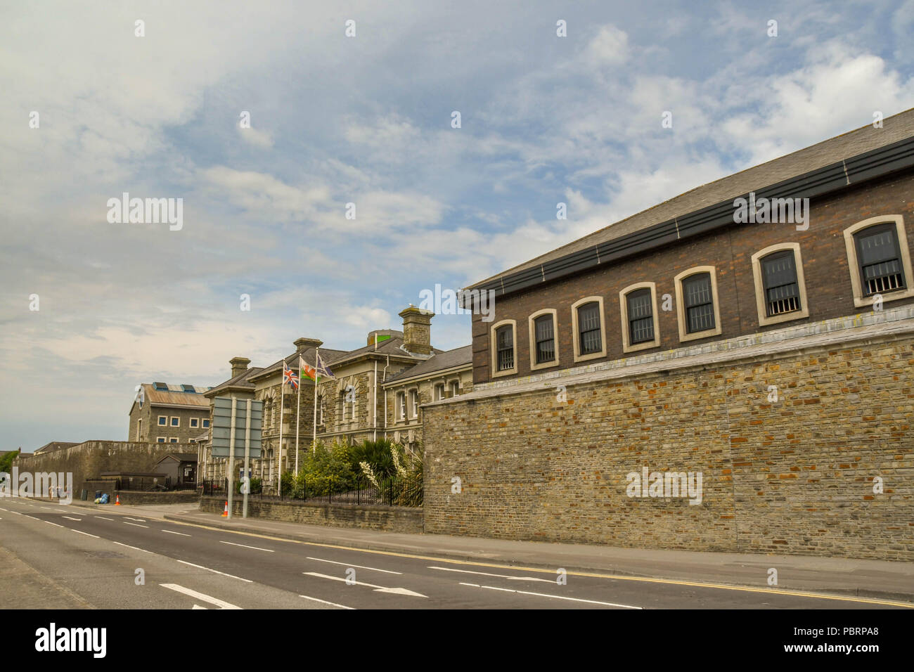 Wide angle view of the high wall and building of HM Prison Swansea Stock Photo