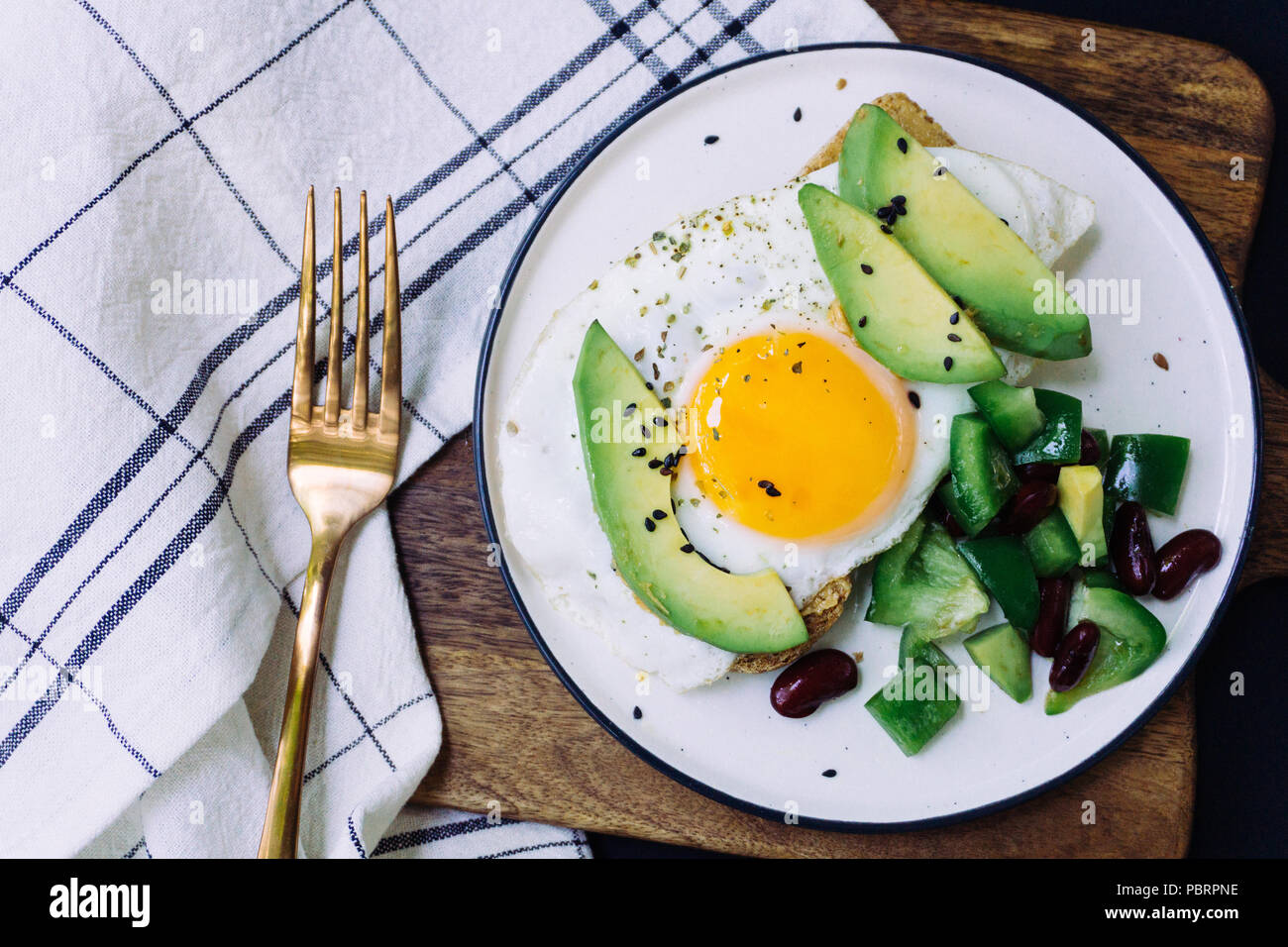 A healthy breakfast of toast with avocado, whole wheat bread and fried