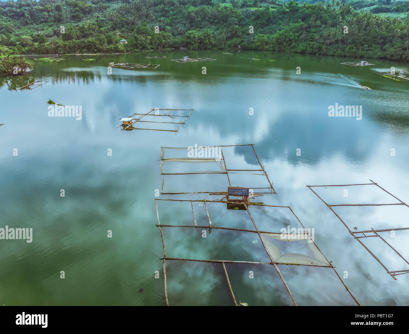 Bamboo rafts and the mountain background of Lake Mohicap, San Pablo City, Laguna, Philippines Stock Photo