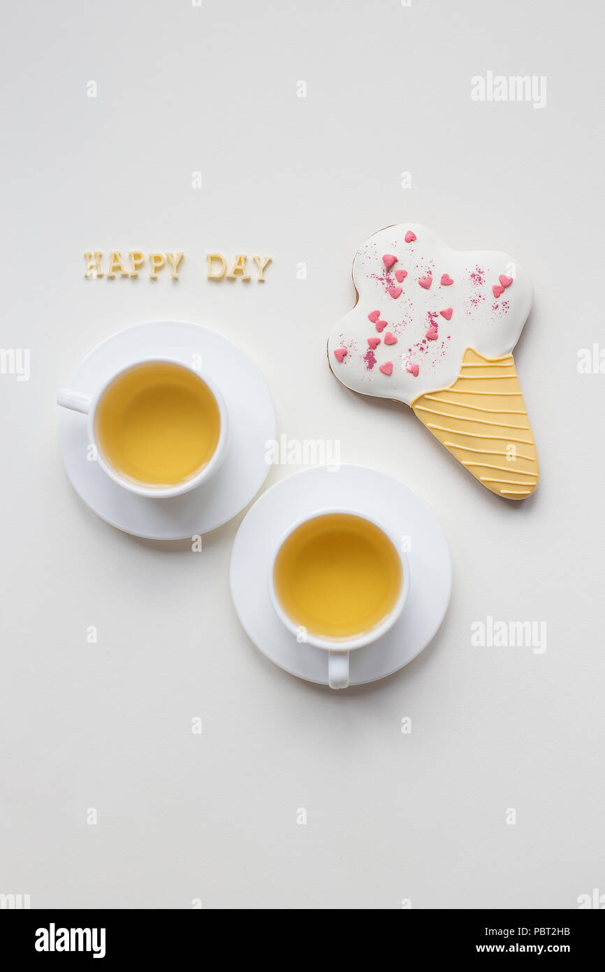 two cups of coffee on a table with cookies Stock Photo