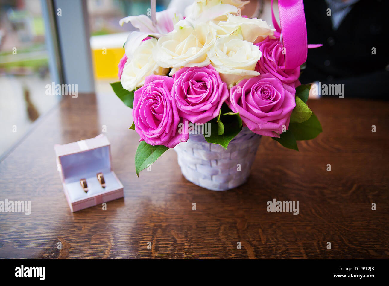 bouquet of beautiful and colorful flowers and wedding rings in a box ...