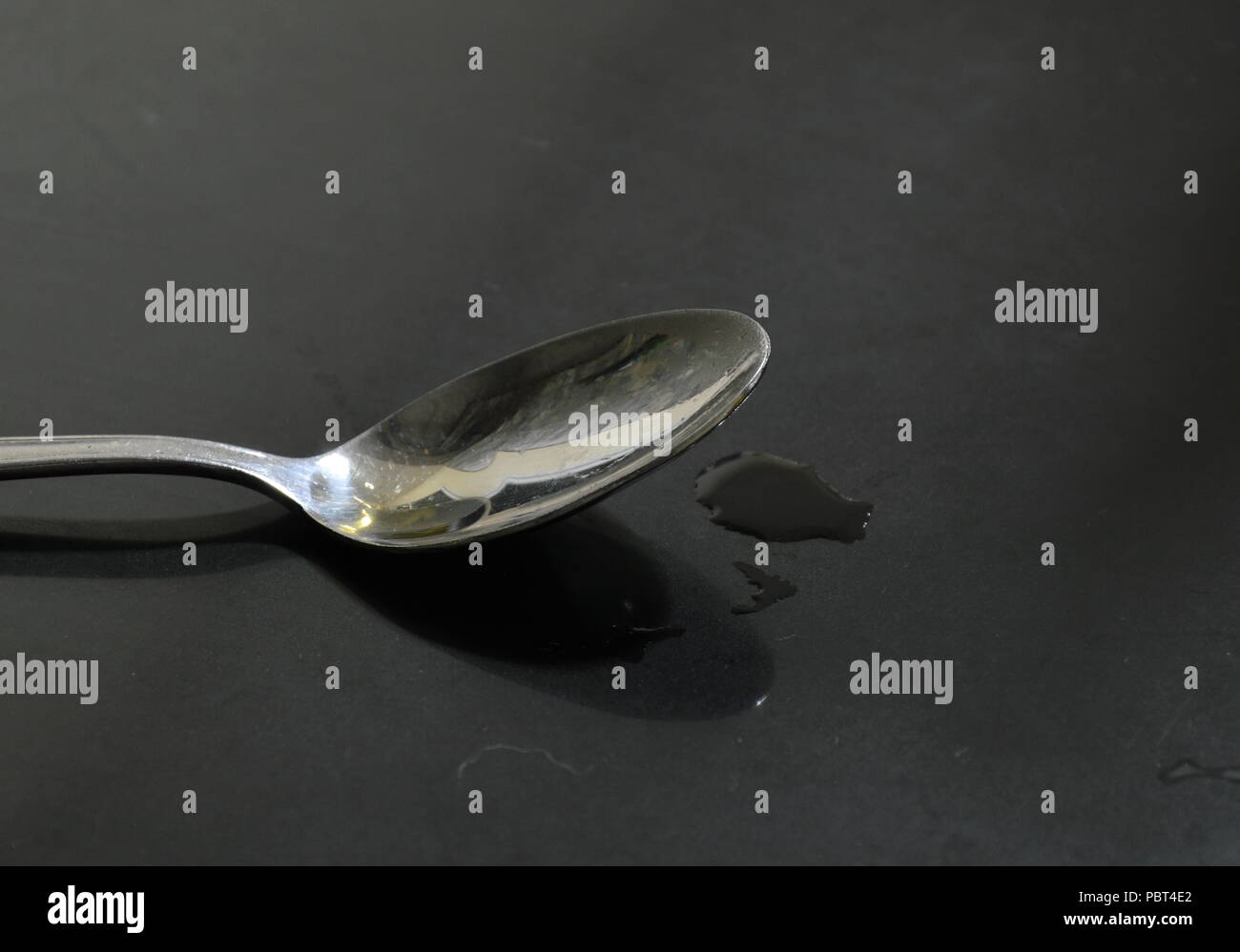 tea spoon on black counter Stock Photo
