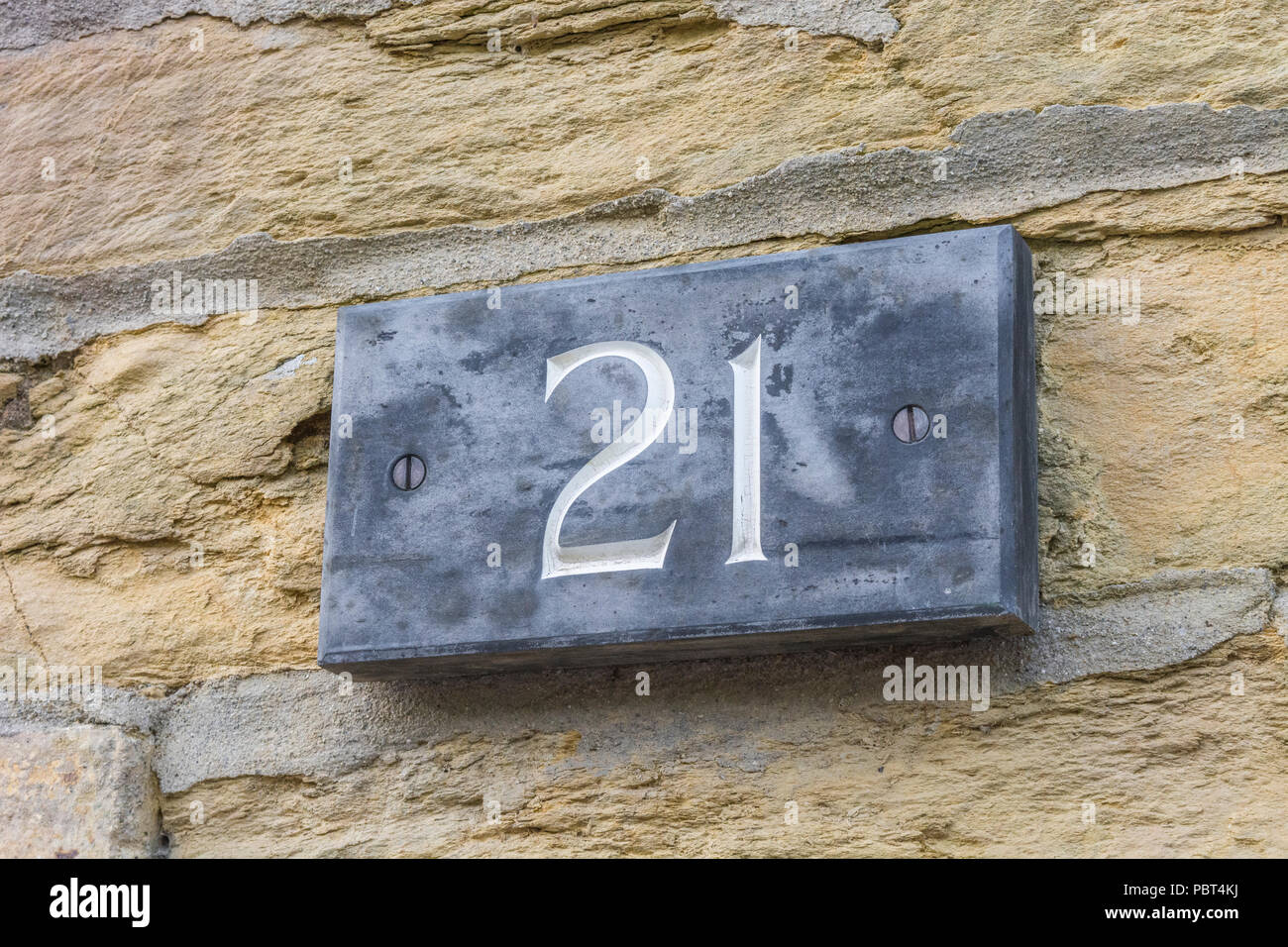 House number 21 on exterior of dwelling. Odd number. Stock Photo