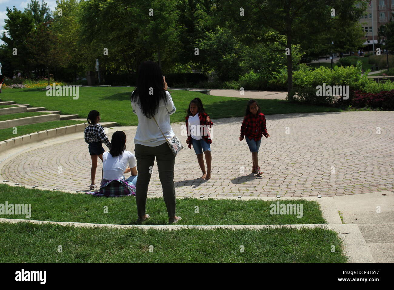 Local girls dancing in an outdoor theater in the park. Stock Photo