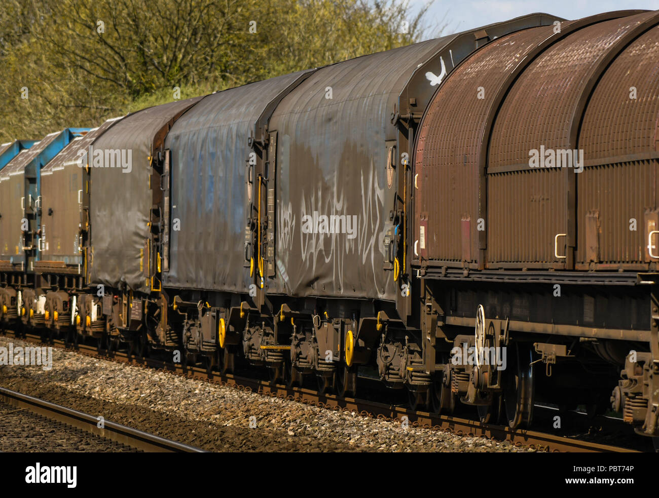 Close up view of part of a long and heavy rail freight train of wagons Stock Photo
