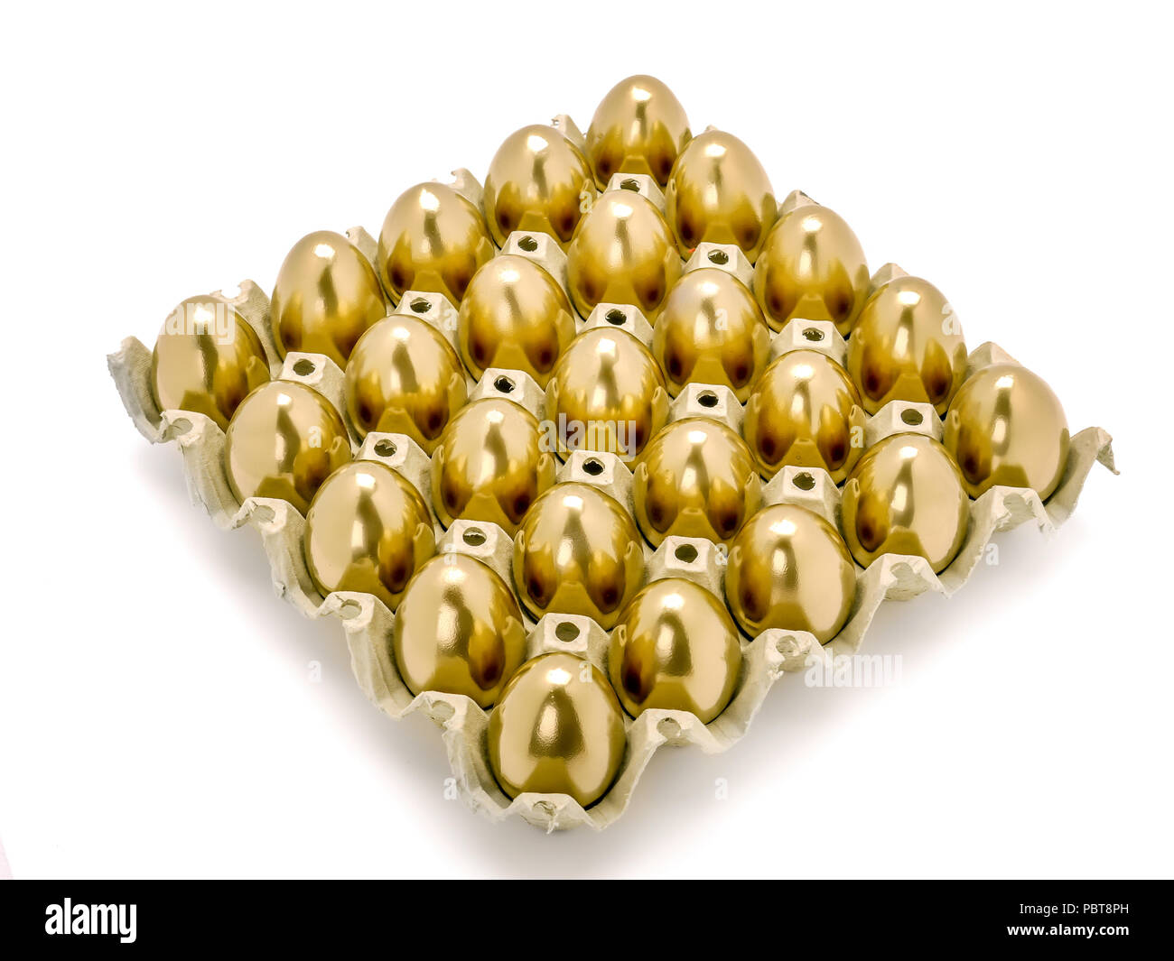 Bunch of golden eggs in egg tray shot on white background Stock Photo
