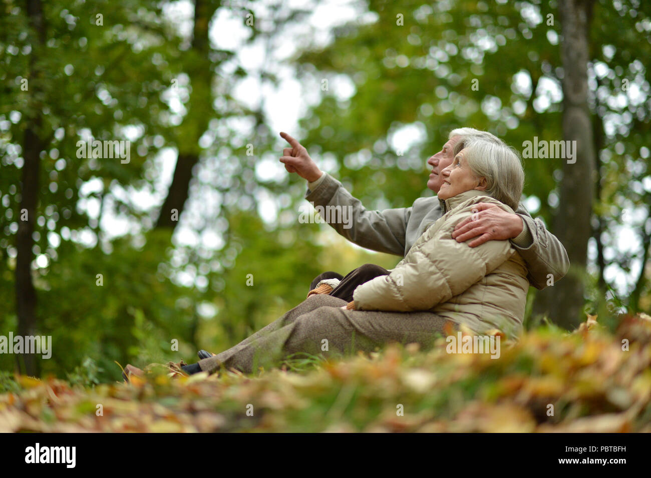 happy Senior couple sitting  in park.  Stock Photo